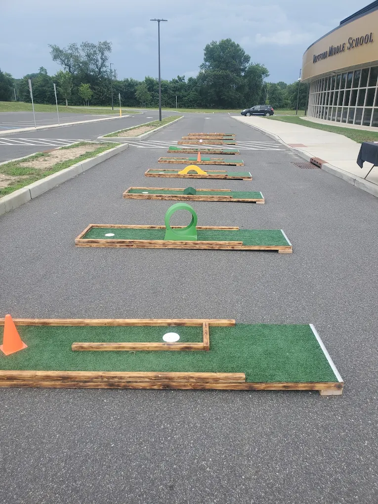 Line-up of mini golf holes at an outdoor event